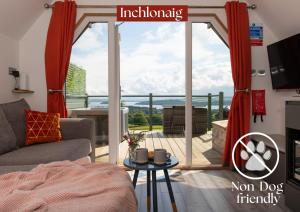 a living room with a view of a balcony at Bonnie Barns - Adults Only Luxury Lodges with hot tubs in Luss