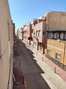 une rue vide dans une ruelle entre bâtiments dans l'établissement Agatha CaboGata Home - Summer Vibes, à Cabo de Gata 1 autre photo