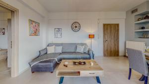 a living room with a couch and a coffee table at Leonidas Family Apartment 1 in Pómbia