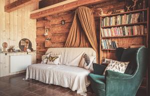 a bedroom with a bed and a chair and books at Pod lasem i niebem in Lanckorona
