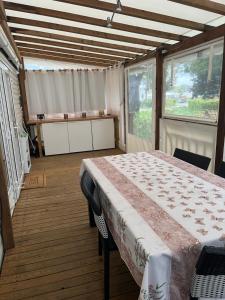 a room with a bed with a table in it at Joelle et Patrick in Lattes
