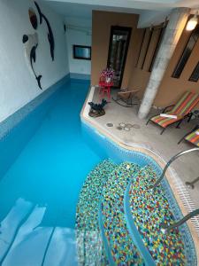 a swimming pool with a bunch of beads on it at Hotel Livin in Tbilisi City