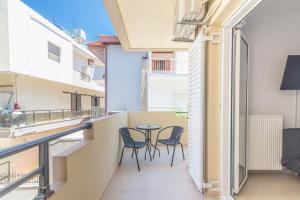 a balcony with two chairs and a table at Urban Apt Next University 12 in Thérissos
