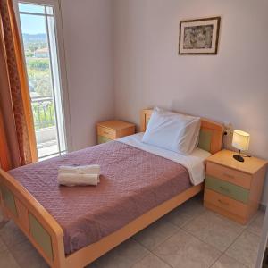 a bedroom with a bed and a window at Aithrea's HOMES in Pastida Rhodes in Pastida