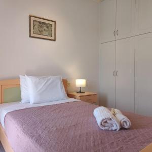 a bedroom with a bed with towels on it at Aithrea's HOMES in Pastida Rhodes in Pastida