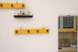 a model of a boat hanging on a wall at Amberi Tinos in Panormos in Pánormos