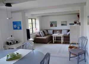 a living room with a couch and a table at Ferienhaus Tade Bo in Süderstapel