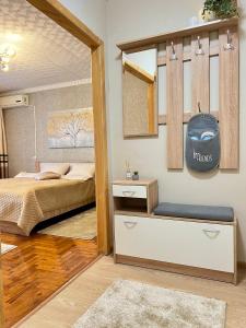 a bedroom with a bed and a mirror at Центр Торговиця 1 кімнатні апартаменти in Ternopilʼ
