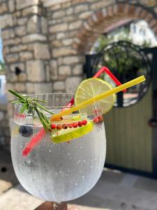 a drink with a lemon and a stick in it at Escape Vama Veche in Vama Veche