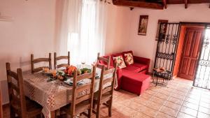 un salon avec une table et un canapé rouge dans l'établissement CHC - La Oliva I, à Buenavista del Norte 14 autres photos