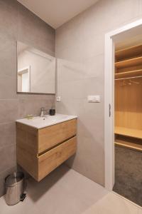 a bathroom with a sink and a mirror at Hotel Taxis Bratislava in Bratislava