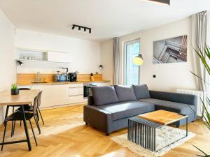 a living room with a couch and a table at Lakepark Residence in Staré Splavy