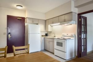 a kitchen with a white refrigerator and a sink at Days Inn by Wyndham Leamington in Leamington