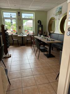 a dining room with tables and chairs in a restaurant at Marina Lauenburg in Lauenburg