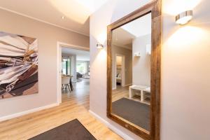 a large mirror on the wall of a hallway at Ferienhaus Beach House Scharbeutz in Scharbeutz