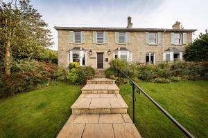 a brick house with a walkway in front of it at Malvern View in Cheltenham