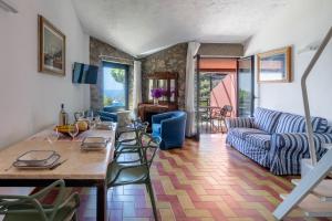 a living room with a table and a couch at Argentarola in Porto Santo Stefano,Pool and Sea View in Porto Santo Stefano