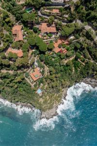an aerial view of a house on an island next to the ocean at Argentarola in Porto Santo Stefano,Pool and Sea View in Porto Santo Stefano
