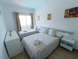 a bedroom with two beds and a window at Benalbeach Paradise in Benalmádena +59 photos