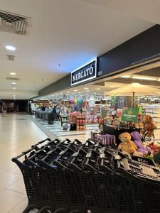 a shopping mall with black chairs in a store at Luxury Suites 118 Island Plaza in Tanjong Tokong