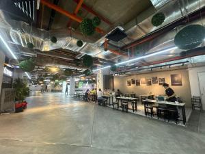 a room with people sitting at tables in a restaurant at Luxury Suites 118 Island Plaza in Tanjong Tokong