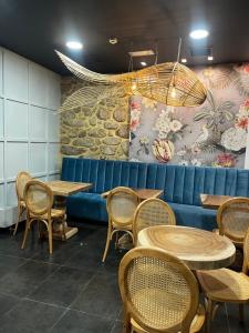 a restaurant with tables and chairs and a wall at Christine Boutique Hotel in El Barraco +45 photos