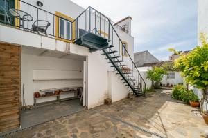 a stairway leading up to a building with a garage at Aqueduct View House in Évora