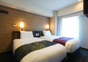 Postel nebo postele na pokoji v ubytování APA Hotel Sakai Ekimae