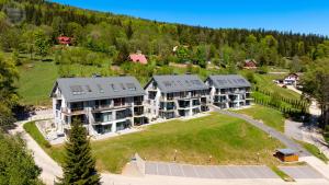 an aerial view of a large house with solar panels at Apartamenty Good Time - Ale Widok! in Szklarska Poręba