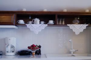 a kitchen with a counter top with a sink and a counter top at Angel Cave Houses in Oia +56 photos