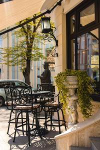 a group of tables and chairs in front of a building at Royal Hotel in Varna City