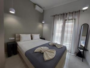 a bedroom with a large bed with bows on it at Apartments Avia in Limenaria