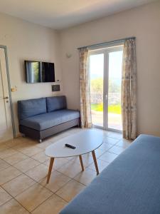 a living room with a couch and a coffee table at Artemis Apartments in Kalyves