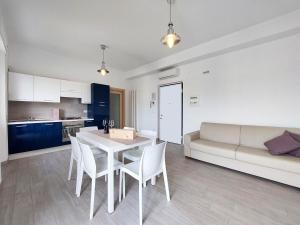a living room with a table and chairs and a couch at Casa Vacanze CuprAmare in Cupra Marittima