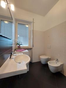 a bathroom with a tub and a sink and a toilet at Casa Vacanze CuprAmare in Cupra Marittima +24 photos