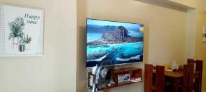 a large flat screen tv hanging on a wall at 316 Tower 3 Avida Atria Iloilo Pool View Comfy Cozy Central in Iloilo City