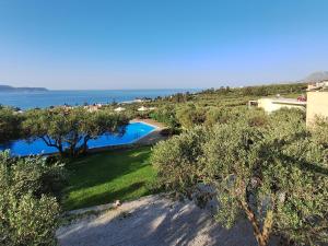an aerial view of a resort with a swimming pool and the ocean at Artemis Apartments in Kalyves