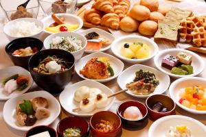 a table full of plates of food on a table at Dormy Inn Nagano in Nagano