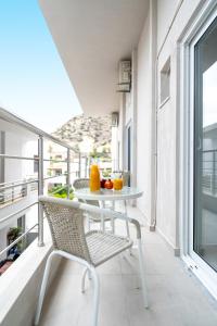 a balcony with a table and oranges on it at Faflagos Apartments in Psari Forada