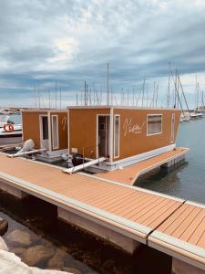 a small boat parked at a dock in the water at Viva Suitesboat in Marina di Montenero