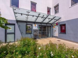 an outside view of a building with a glass door at Première Classe Chartres Sud - Barjouville in Chartres +28 photos