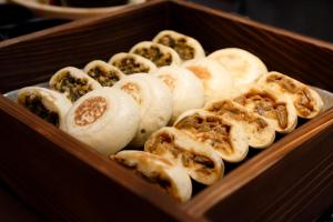 a wooden box filled with different types of food at Dormy Inn Nagano in Nagano