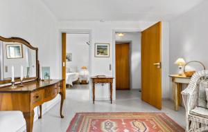 a living room with a desk and a mirror at 1 Bedroom Cozy Home In Nykøbing M in Flade +9 photos