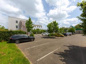 a parking lot with several cars parked in it at Première Classe Chartres Sud - Barjouville in Chartres