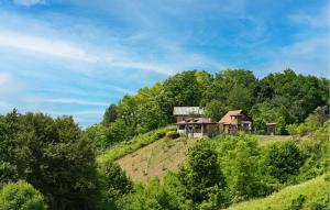 a house on top of a hill in the forest at One-Bedroom Holiday Home In Donja Voca in Gornja Voća +33 photos