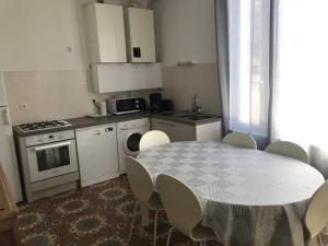 a kitchen with a table and a table and chairs at Gite le Vaudésir in Ligny-le-Châtel