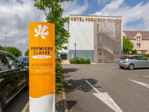 a sign in the parking lot of a car dealership at Première Classe Chartres Sud - Barjouville in Chartres