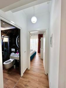 a bathroom with a toilet and a sink and a mirror at The Gwen in Sarandë +74 photos