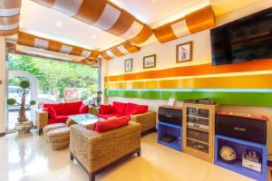 a living room with red couches and a tv at Ocean Star B&B in Kenting