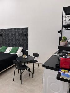 a bedroom with a bed and a table and chairs at Olina residence 2 in Naples